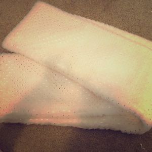 This is a faux fur scarf that has silver dots.